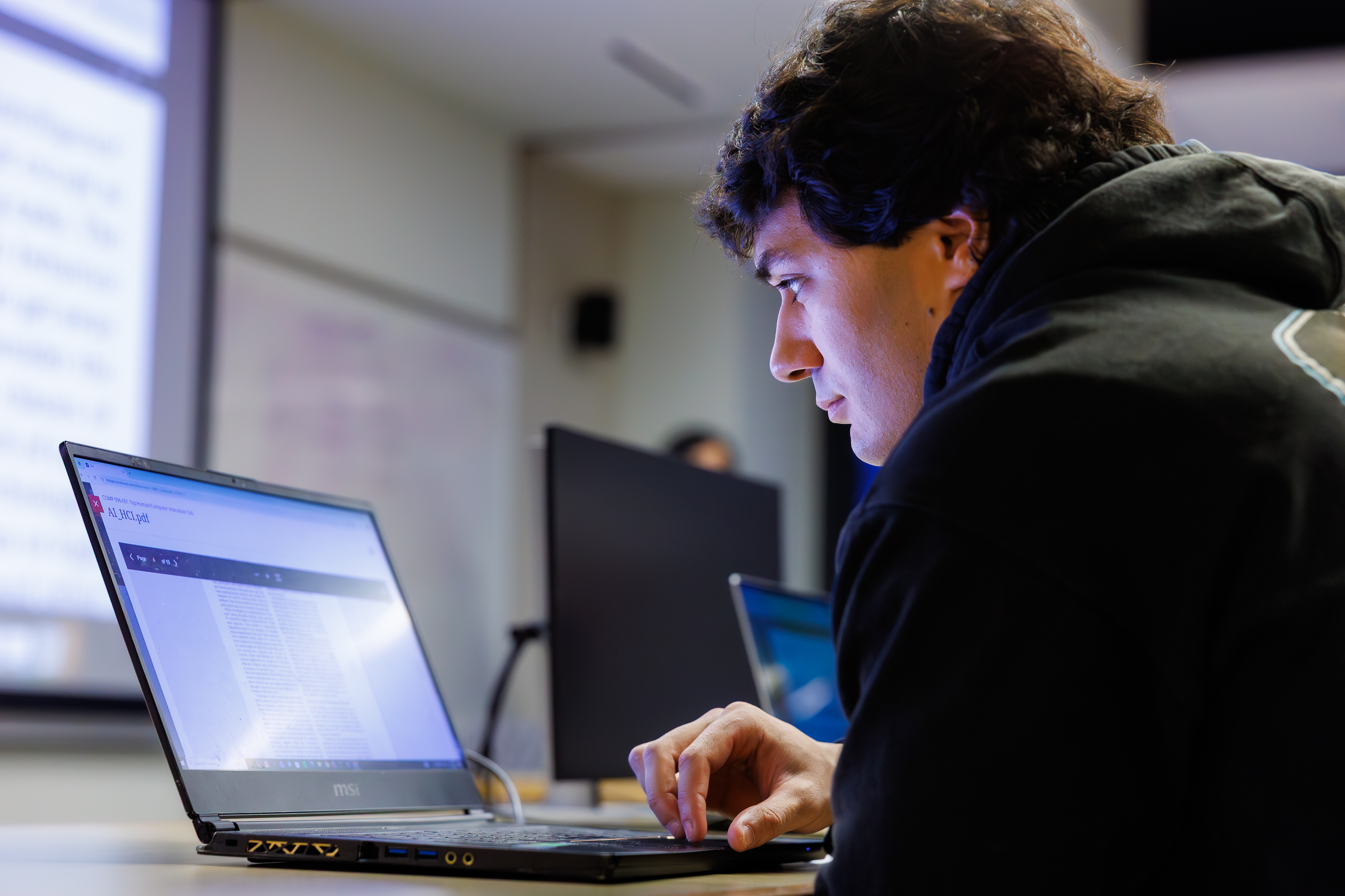 Man on laptop looking at a database