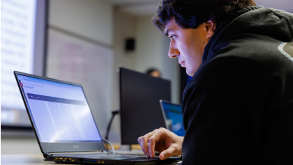 Man on laptop looking at a database